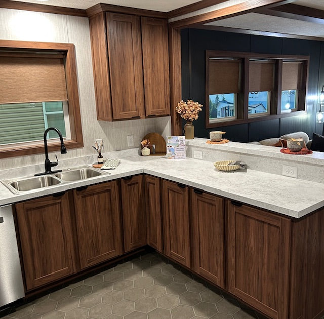 Modern kitchen with wooden cabinets, granite countertops, and a sink.
