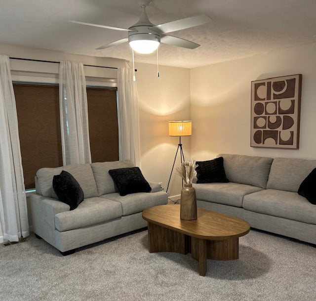 Living room with gray sofa, wooden coffee table, and decorative elements.