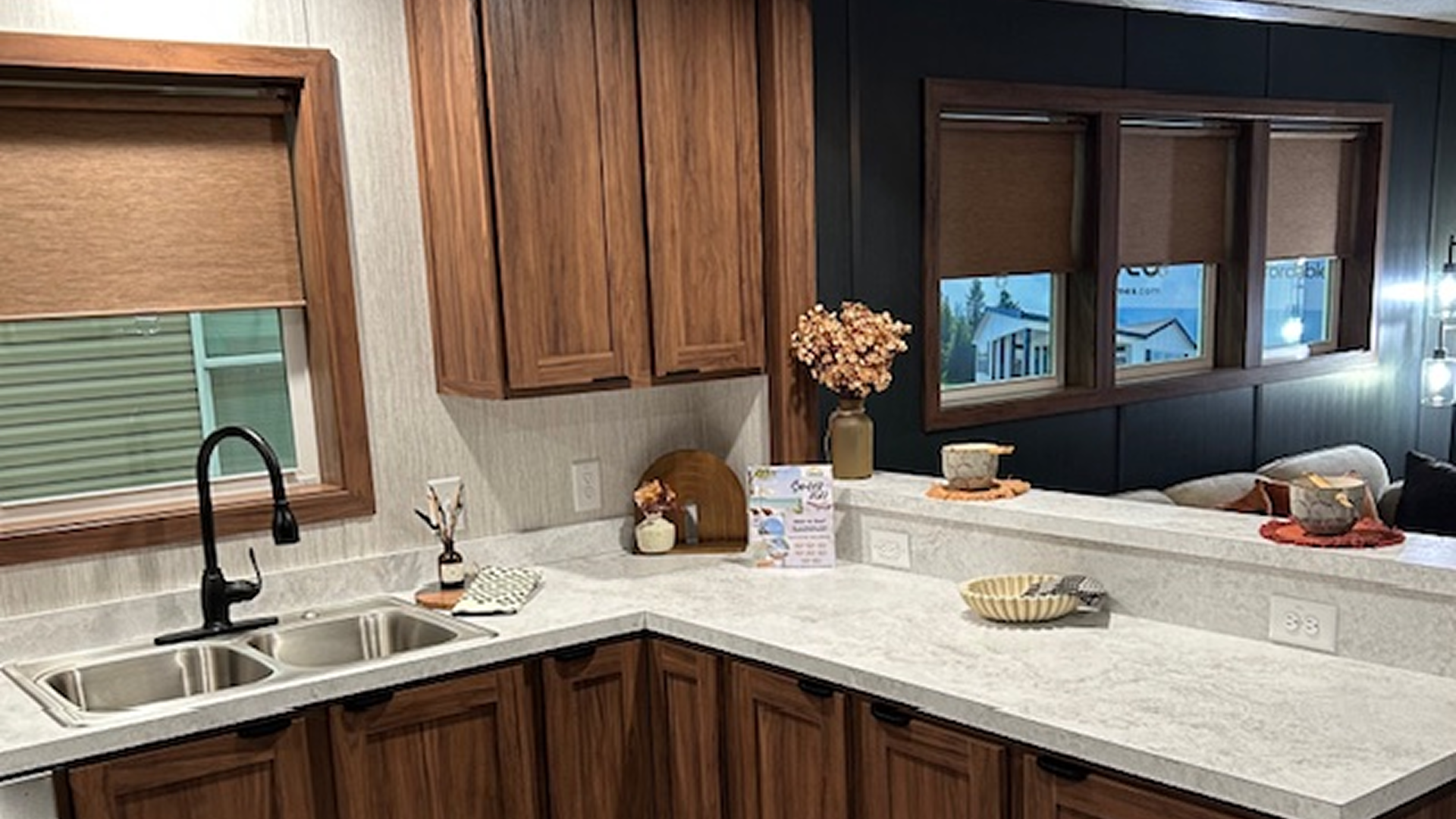 Modern kitchen with wooden cabinets, granite countertops, and a sink.
