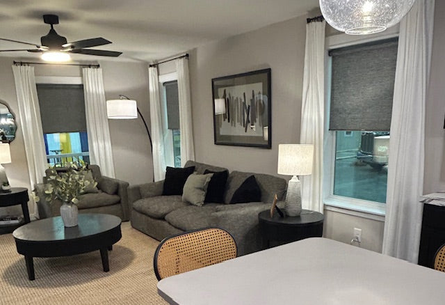 Living room with gray sofa, coffee table, and decorative elements.