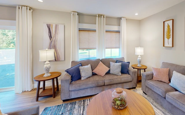 Living room with gray sofa, wooden coffee table, and decorative pillows.