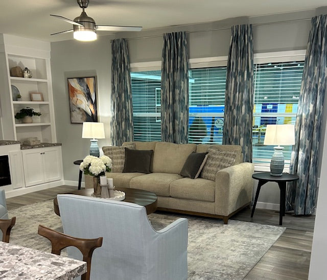 Living room with beige sofa, armchair, and decorative elements.